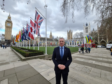 Rob in Parliament Square with the flags of the Commonwealth